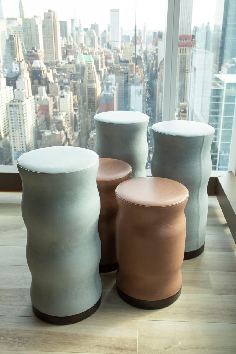 custom leather wrapped curvy stools in NYC building