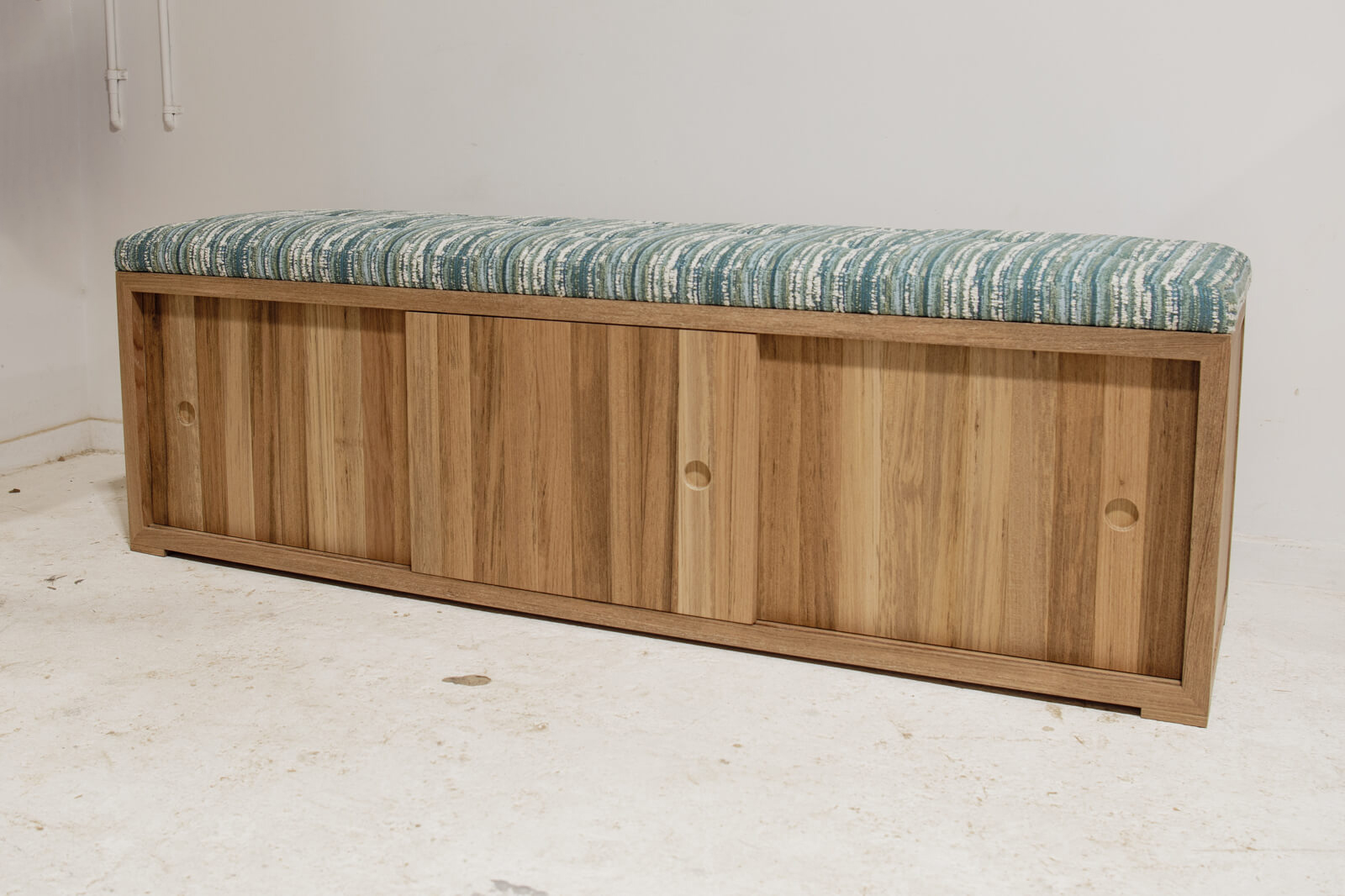 Custom outdoor teak bench with upholstered top