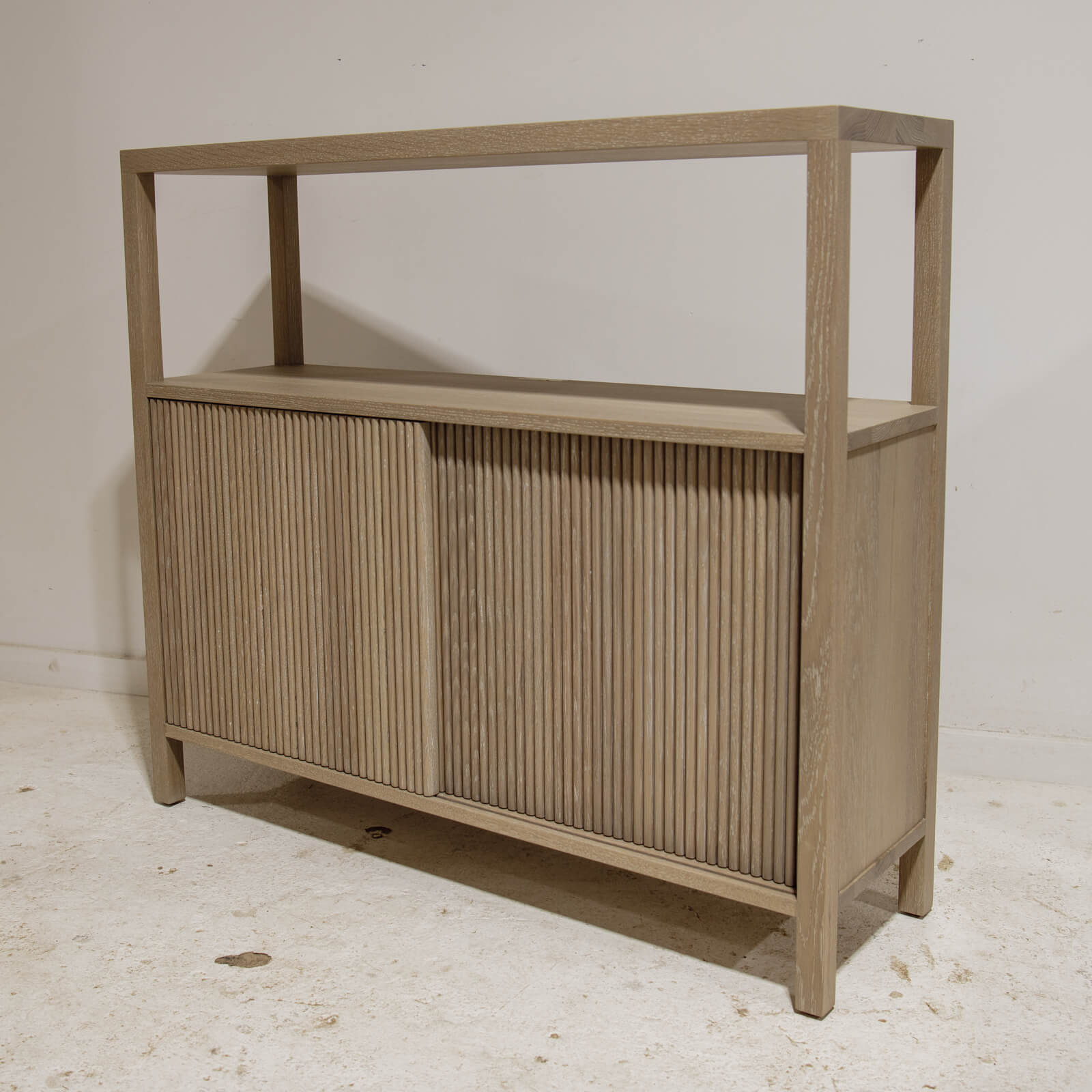 Custom white washed oak cabinet with reeded doors