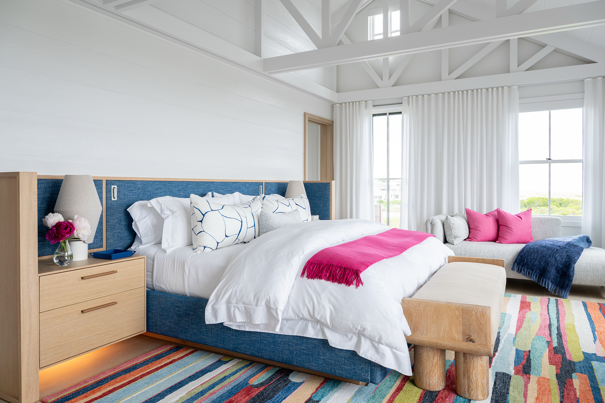 Custom oak platform bed with upholstered headboard and integrated nightstands